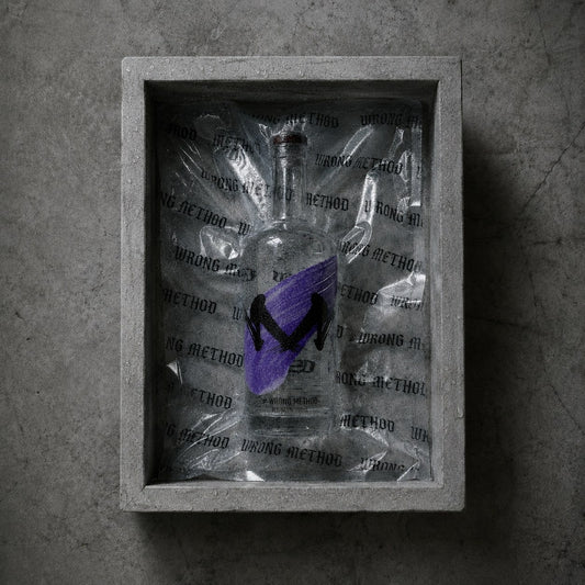 A bottle of WRONG METHOD sake resting in a concrete box